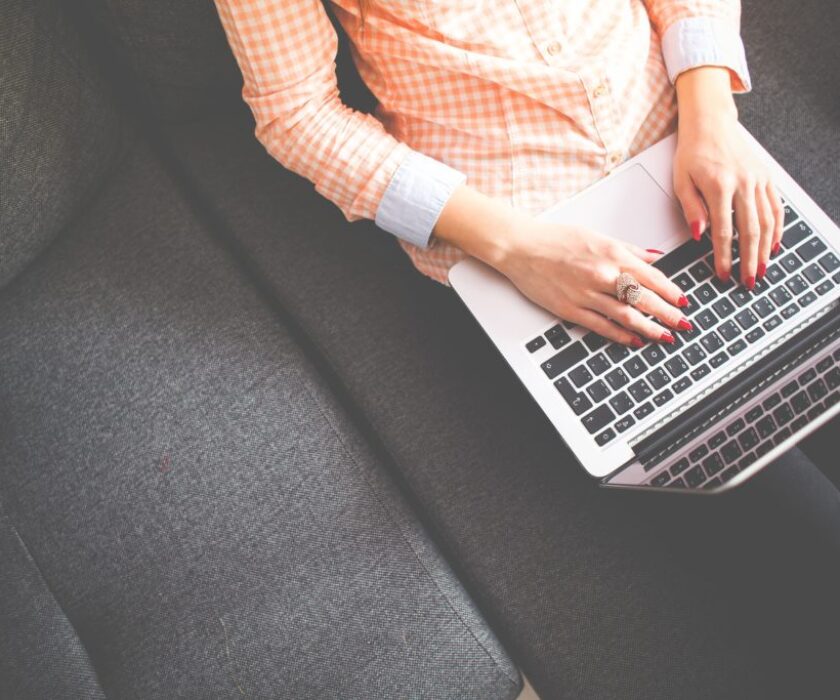 Woman typing on laptop. Image used for blog post "The importance of Blogging"