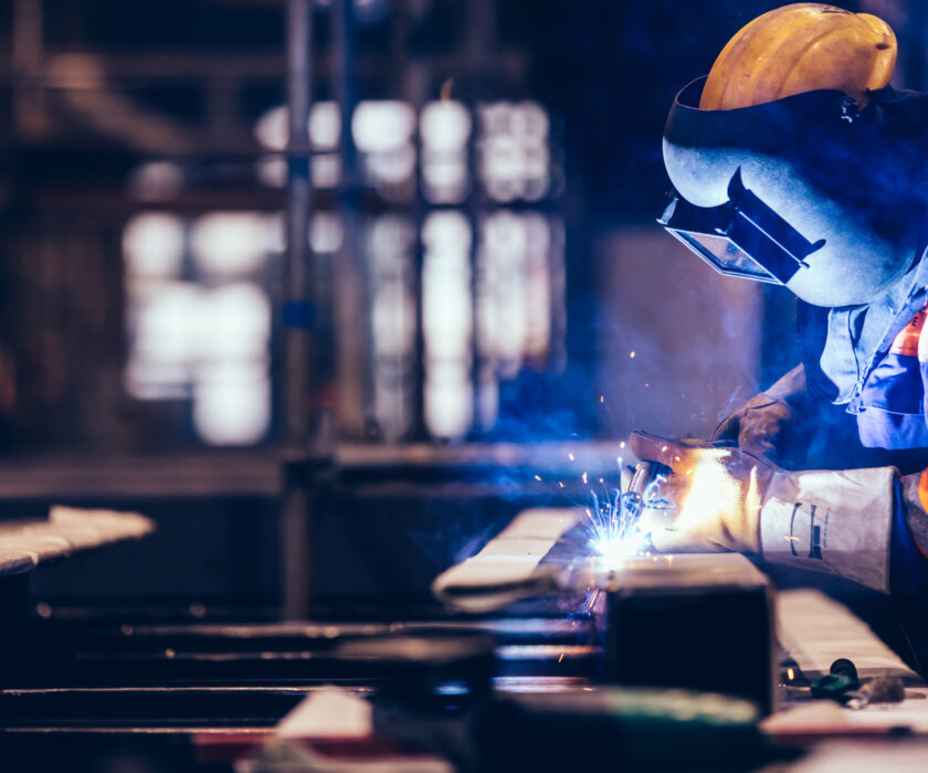 Worker welding in a factory.